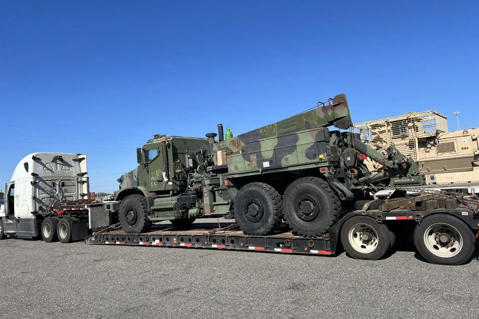 Heavy military vehicle secured on a lowboy trailer for an oversized freight move